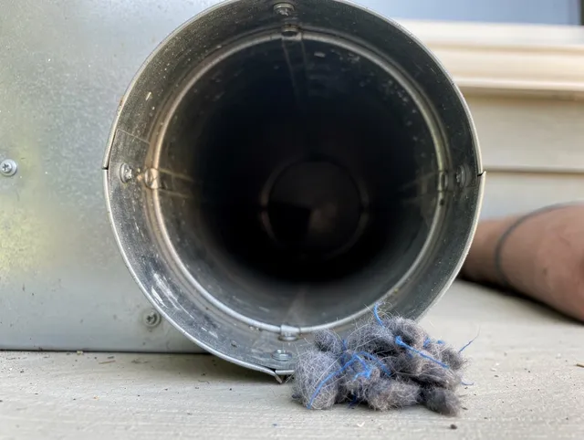 Groton Dryer Vent Cleaning technician using specialized equipment to clear severe dryer vent blockage in Groton